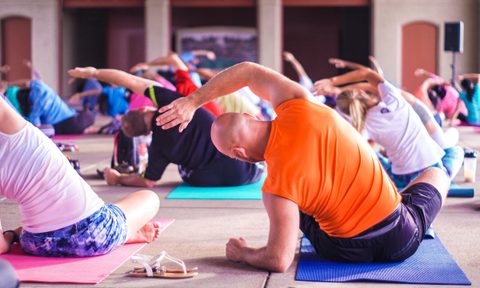 yoga class side bend seated on mats