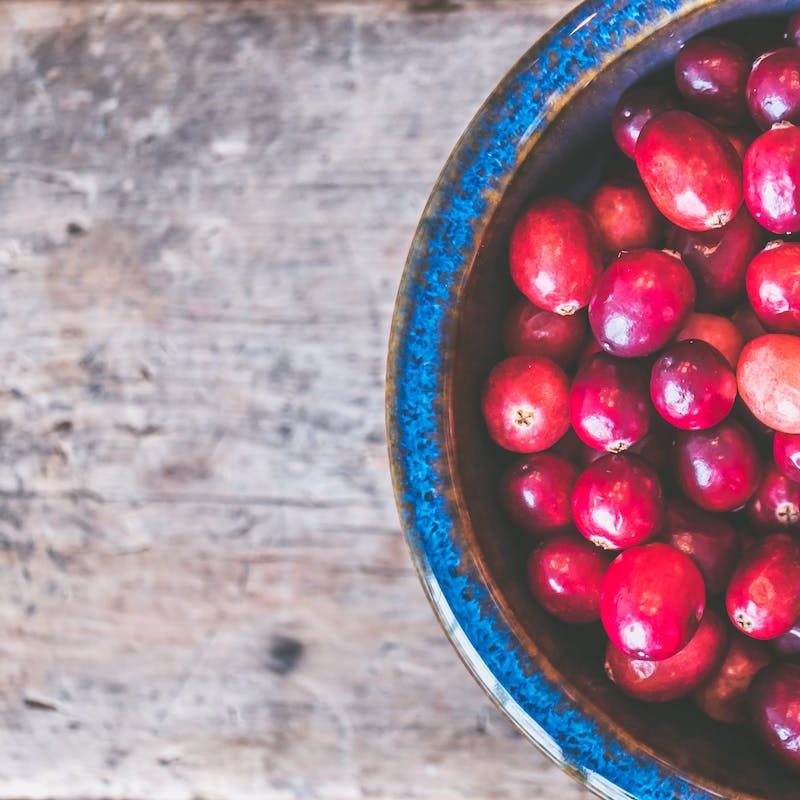 A blue bowl of cranberries