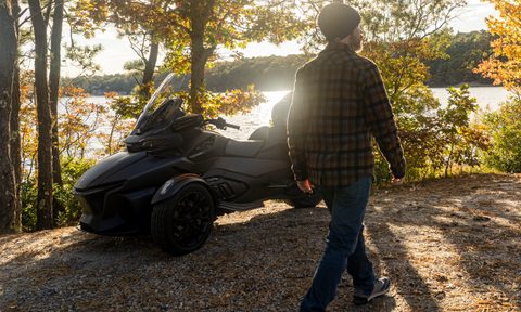 Man walking in front of a CAN-AM Spyder RT Limited three-wheeler.