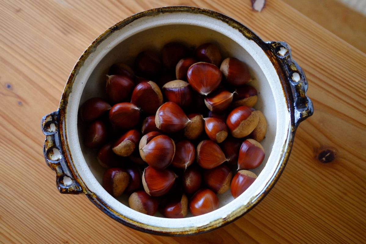 chestnuts in a bowl on a wooden table