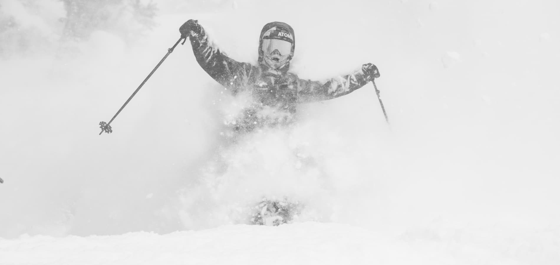 Skier riding through powder at Snowbasin