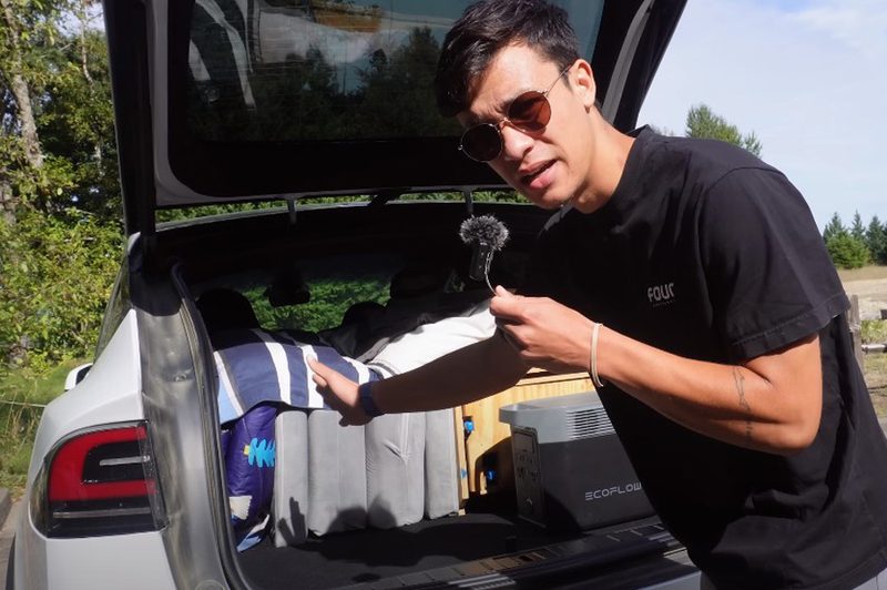 YouTuber Everyday Sandro showing off sleeping quarters in rear of Tesla Model X.
