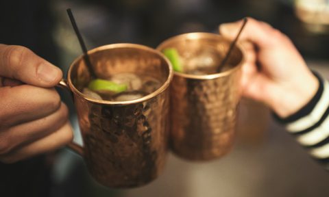 Hands toasting with moscow mules