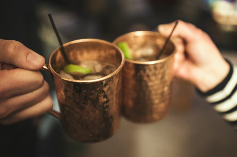 Hands toasting with moscow mules