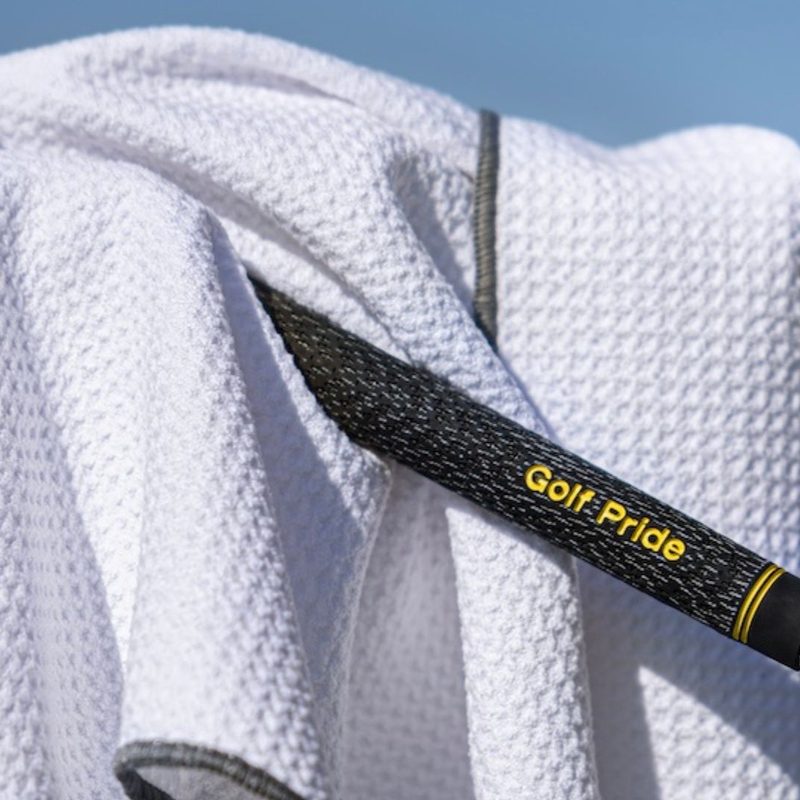 Golf club in a white towel