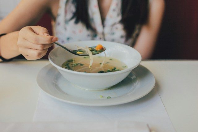 Person eating soup