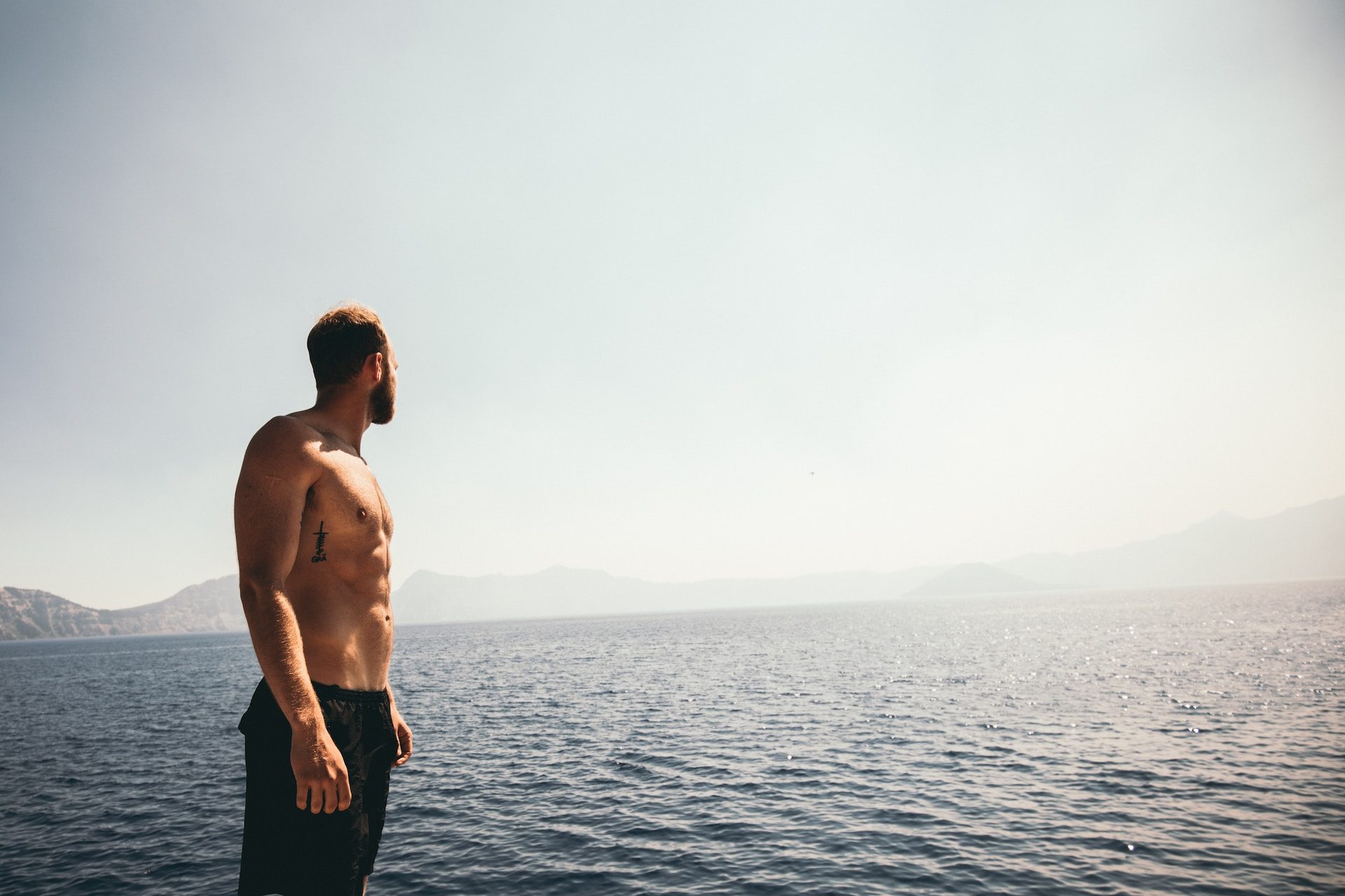 man staring at the ocean