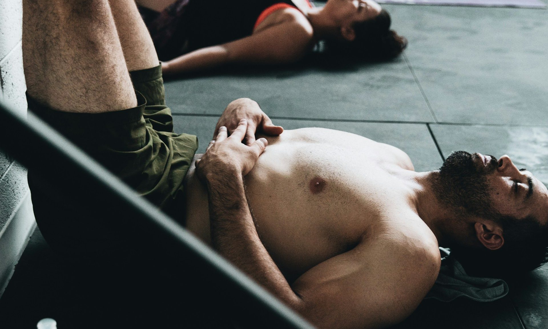 man legs up the wall pic in pilates or gym class wearing shorts