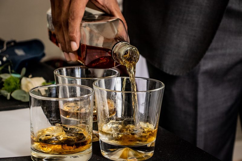 Pouring whiskey into glasses