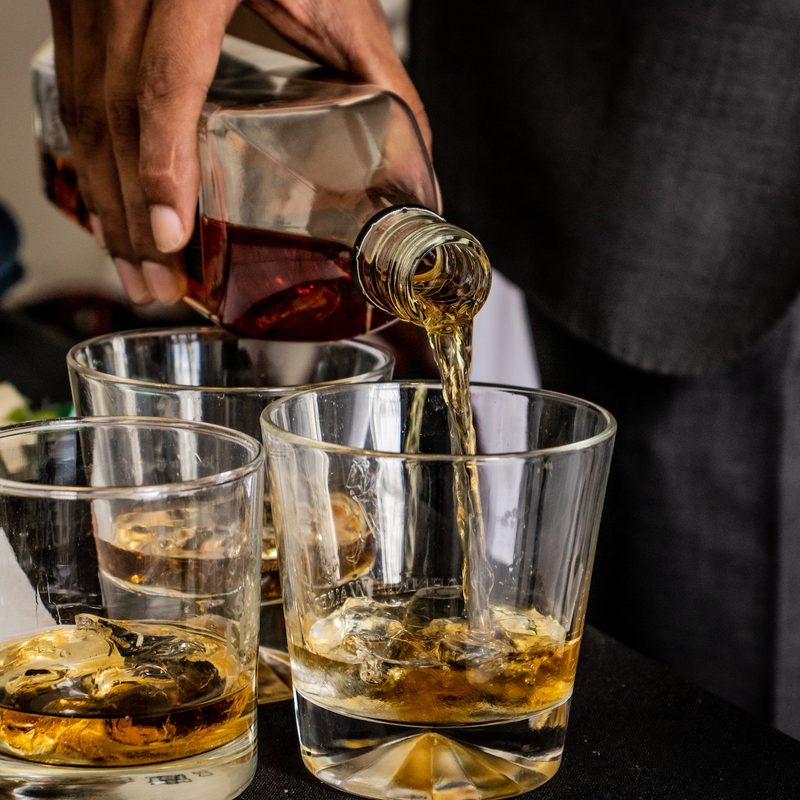 Pouring whiskey into glasses