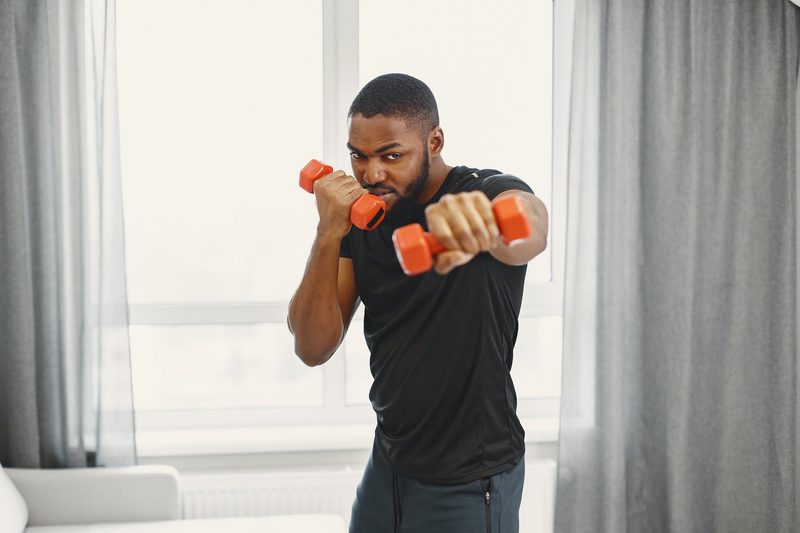 man holding dumbells in workout