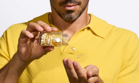 man pouring out Ritual Essential multivitamin capsules