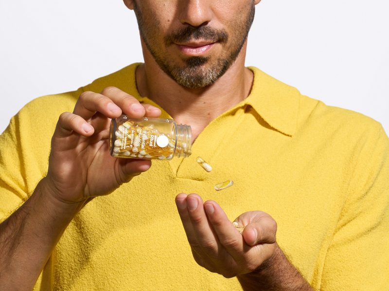 man pouring out Ritual Essential multivitamin capsules