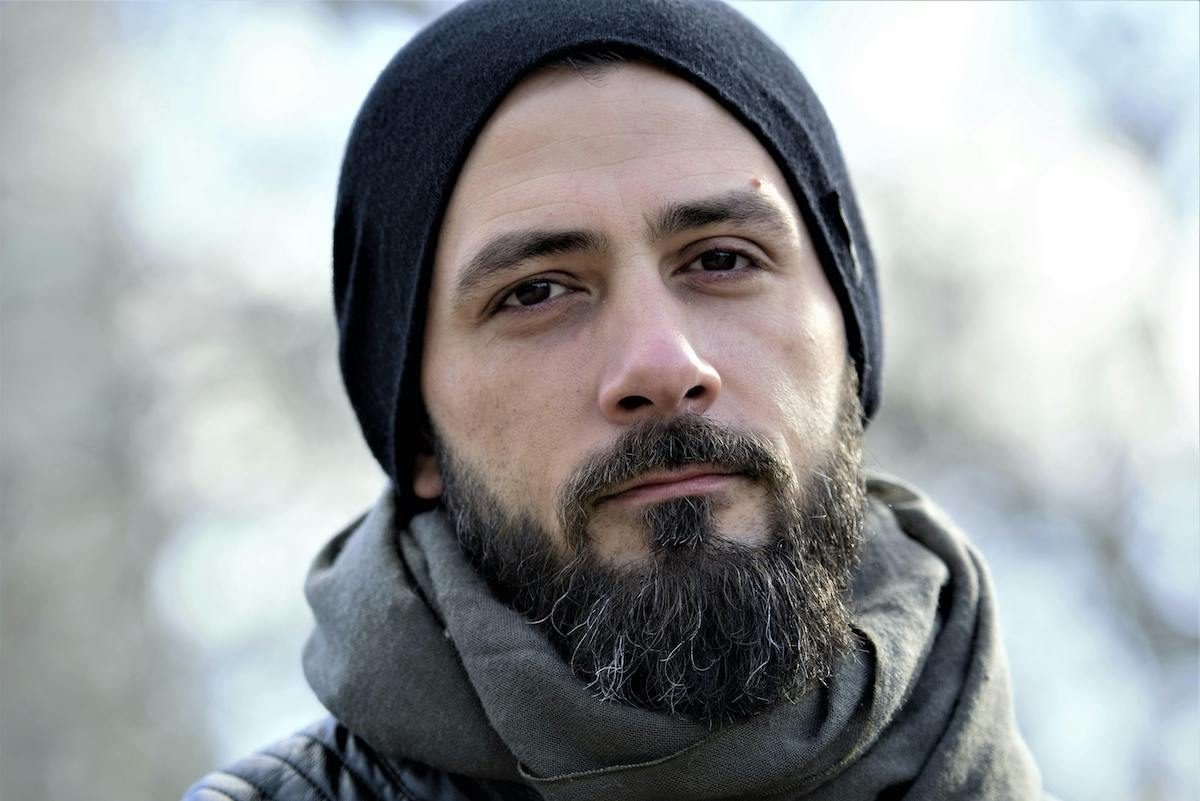 a close up of a man in a beanie