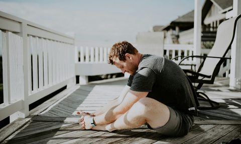 Man doing yoga on deck