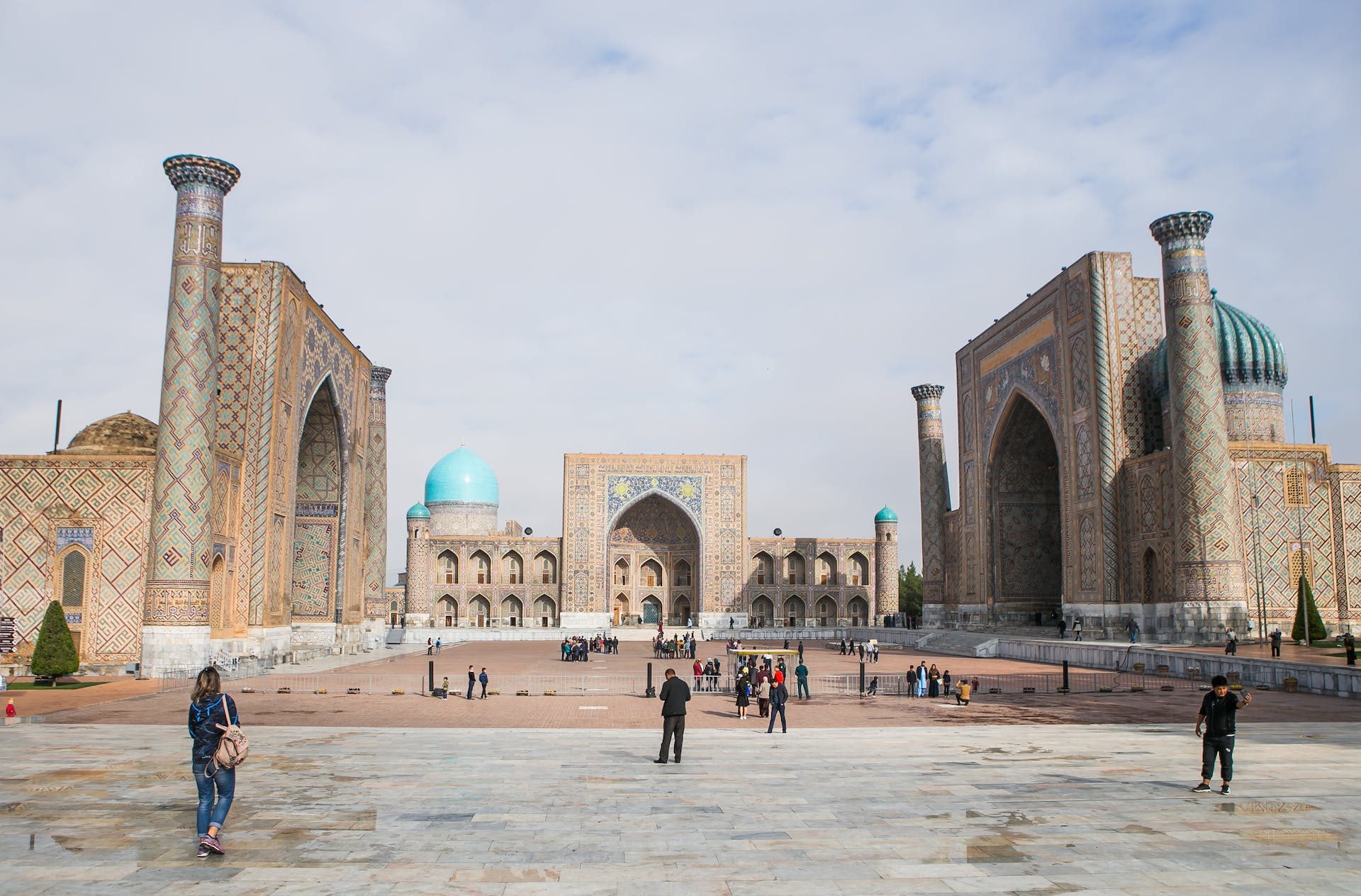 People walking around the famous registan in samarkand