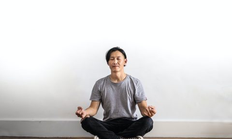 Man sitting on floor cross legged