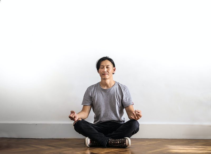 Man sitting on floor cross legged