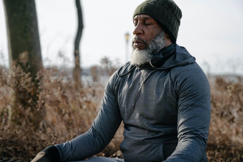 Man sitting outside with eyes closed