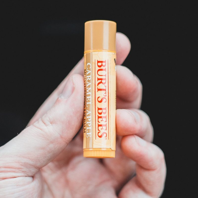 Close-up of hand holding Burt's Bees lip balm