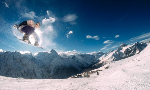 Snowboarder jumping through the air
