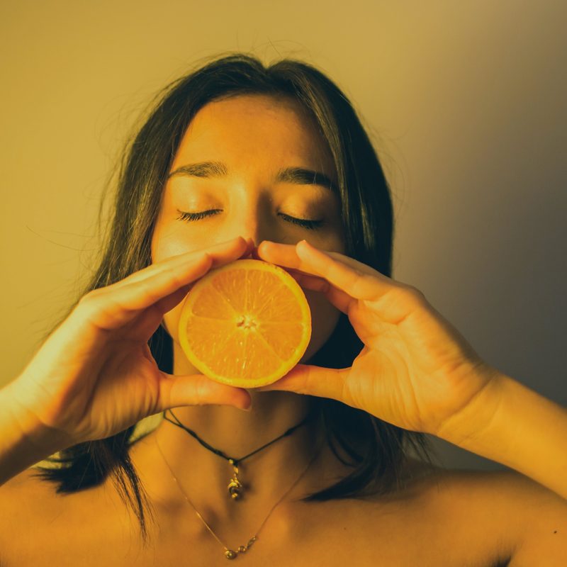 Woman holding an orange slice