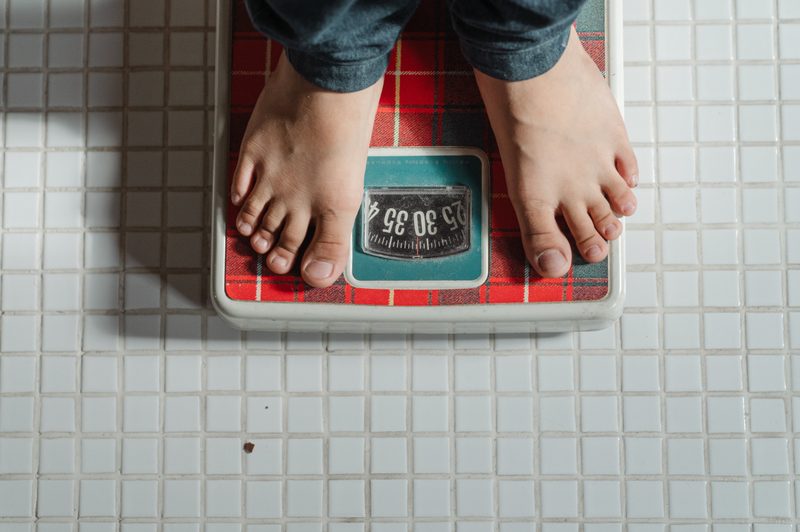 Person standing on bathroom scale