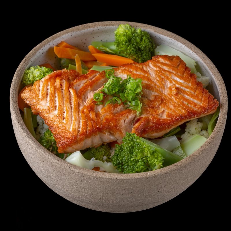 Cooked salmon in bowl of rice