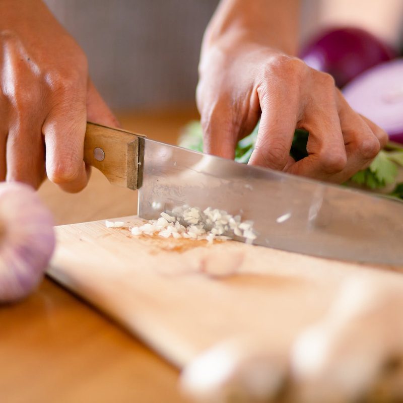 Person mincing garlic