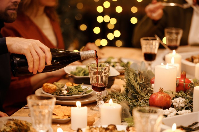 Red wine being poured from bottle into glass