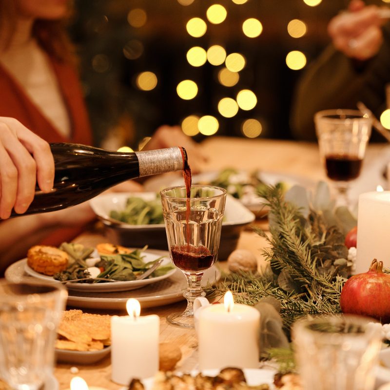 Red wine being poured from bottle into glass