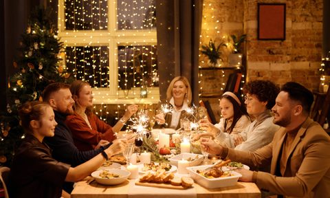 Group of people sharing a holiday meal sitting at the table