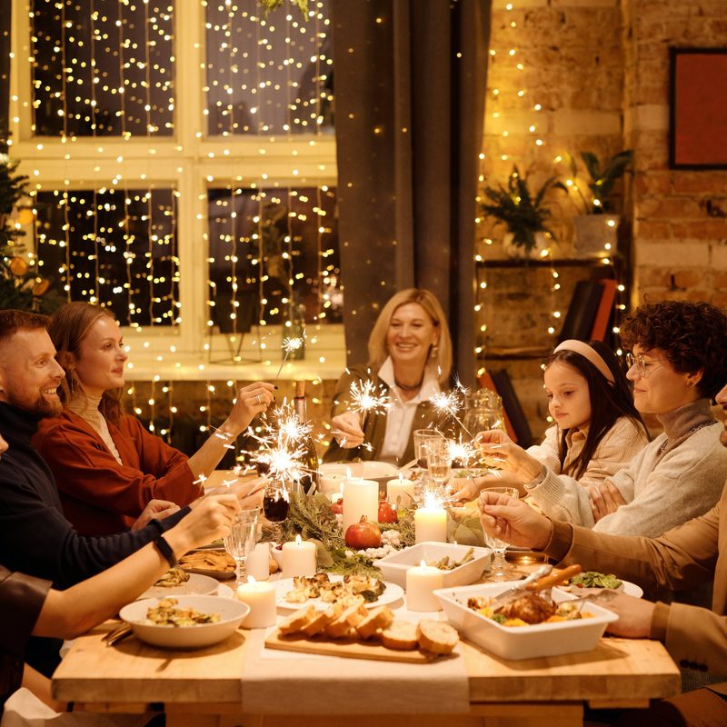 Group of people sharing a holiday meal sitting at the table