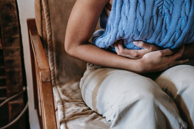 woman holding stomach from constipation