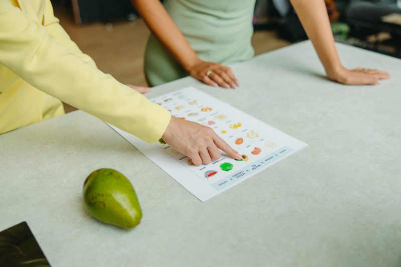 Finger pointing to worksheet with pictures of food