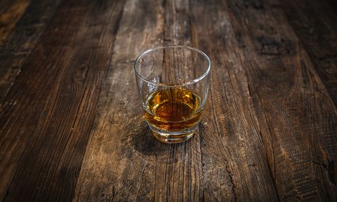 Whiskey in a glass on a wooden table