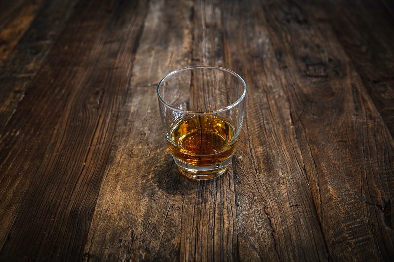 Whiskey in a glass on a wooden table
