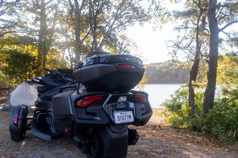 Rear view of a CAN-AM Spyder RT Limited parked near a lake.