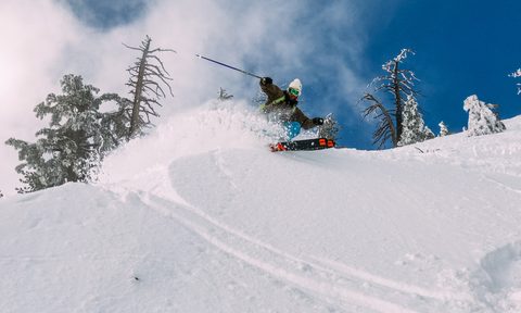 A man skiing in powder.
