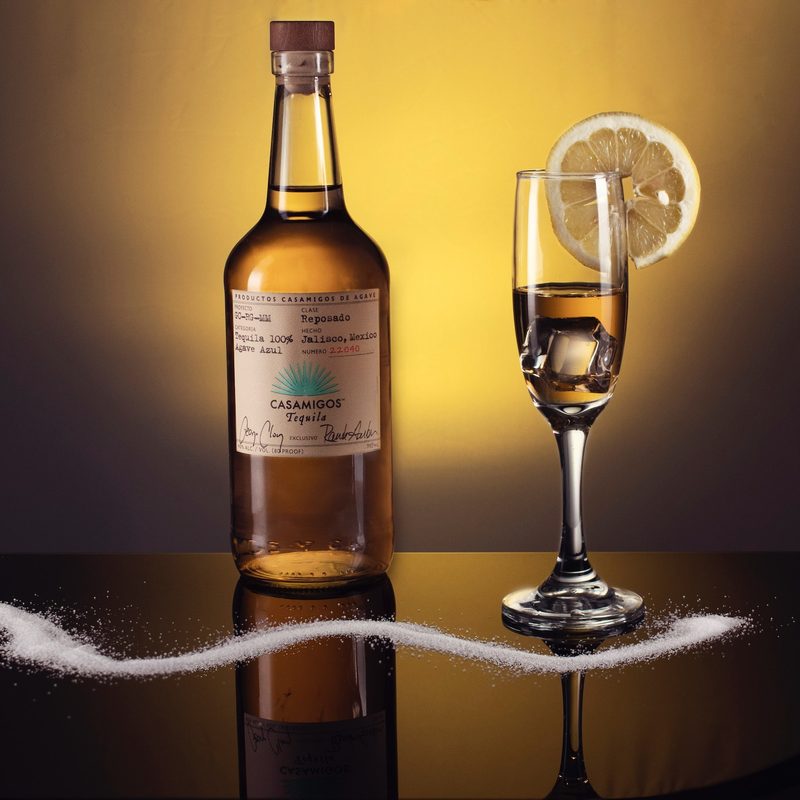 Reposado tequila bottle with a glass of tequila