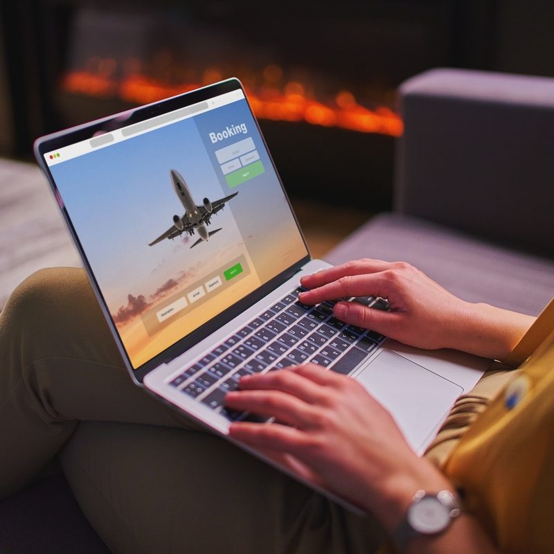 Woman on laptop booking a plane ticket