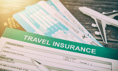 Photo of travel insurance form along with plane tickets.