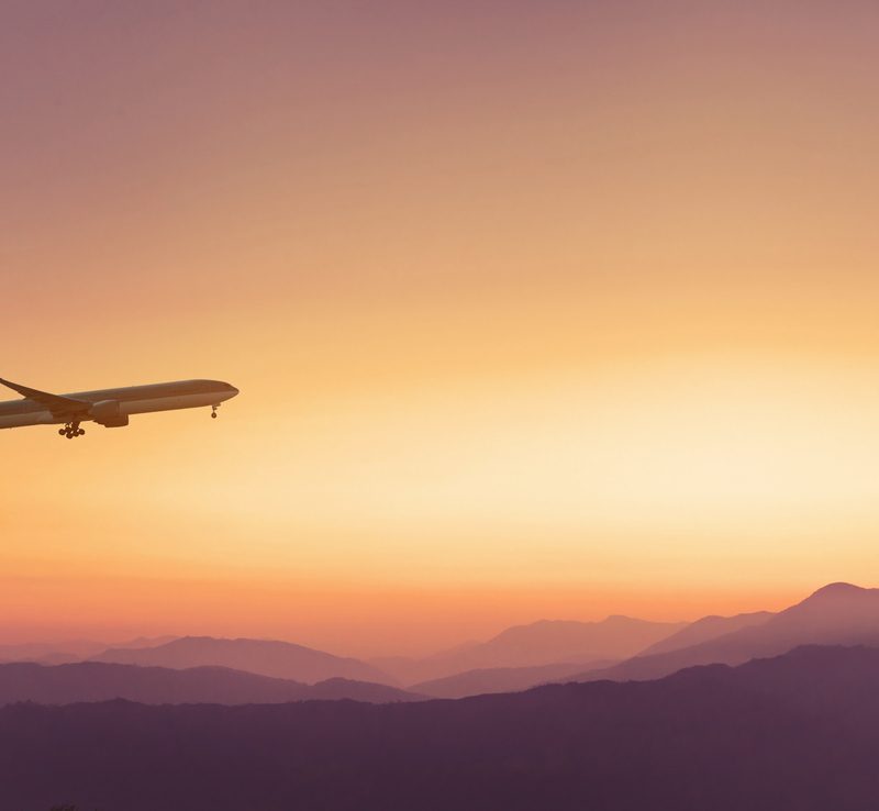 Plane flying in the sky over mountains