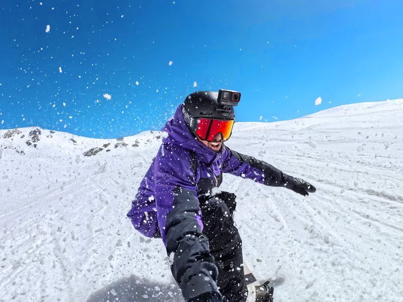 Someone skiing with a camera on their helmet.