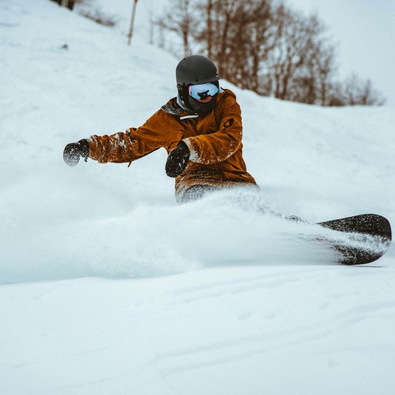 snowboarder powder turn