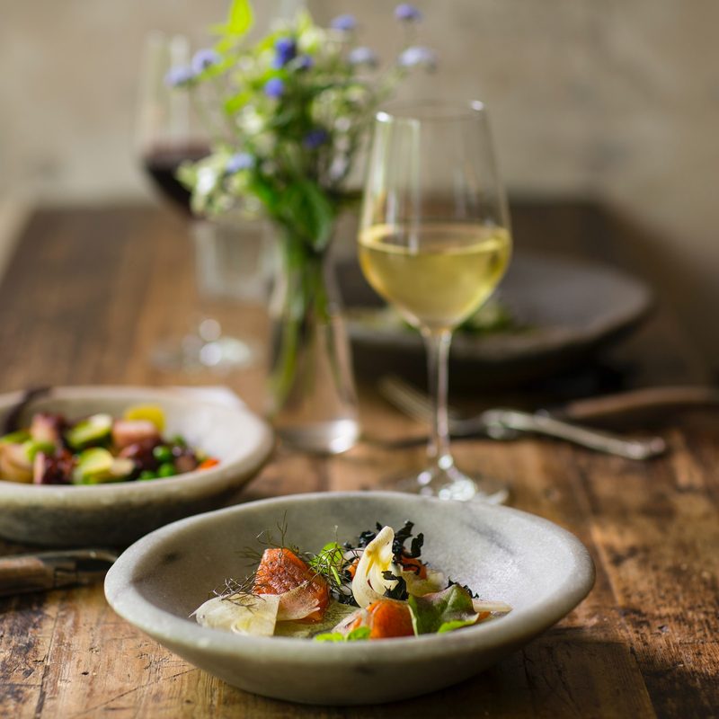 Table set with salads and wine