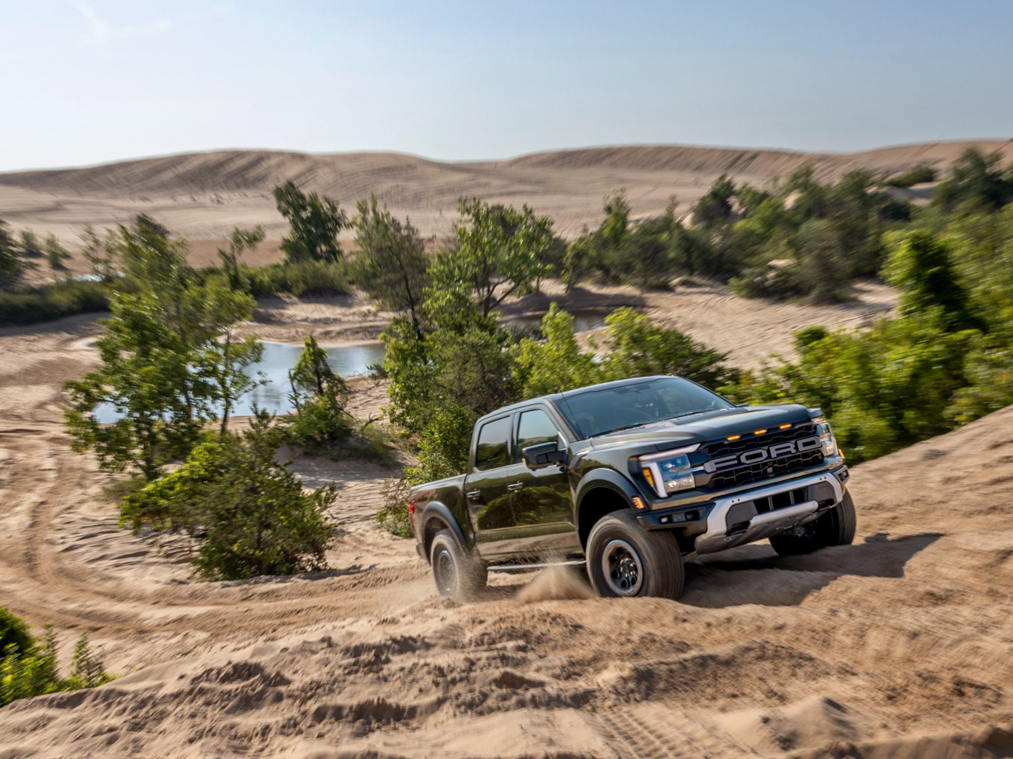 A ford F150 driving through rugged terrain.