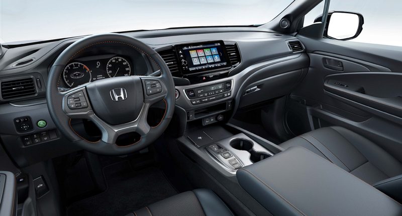 2024 Honda Ridgeline TrailSport interior front seat showing the seats and the dashboard with infotainment display and center console.