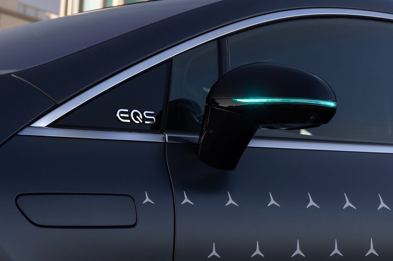 2024 Mercedes EQS equipped with Drive Pilot and left exterior mirror with turquoise light.