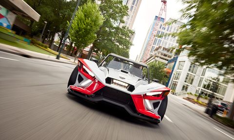 2024 Polaris Slingshot ROUSH Edition on a city street driving straight toward the viewer.